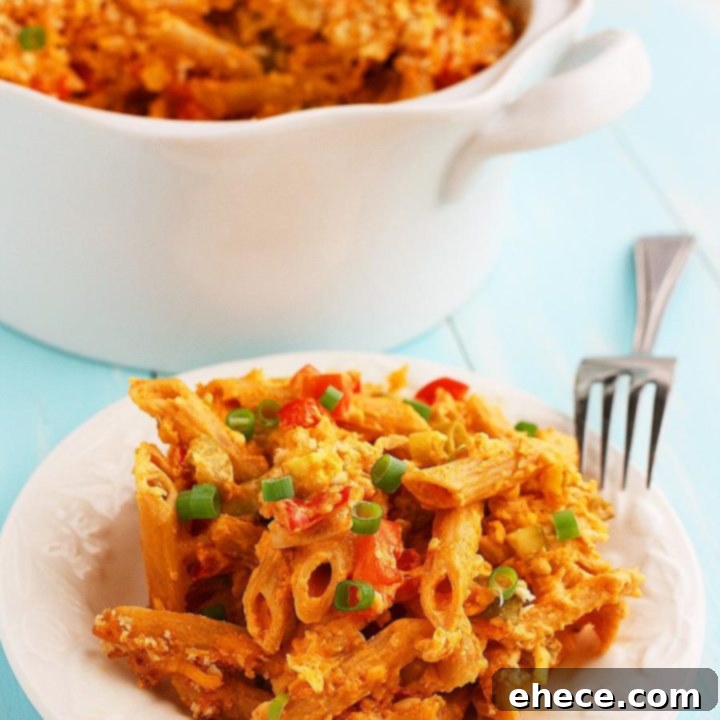A deliciously creamy and zesty Buffalo Chicken Mac 'n Cheese, topped with golden breadcrumbs and fresh green onions, ready to be served
