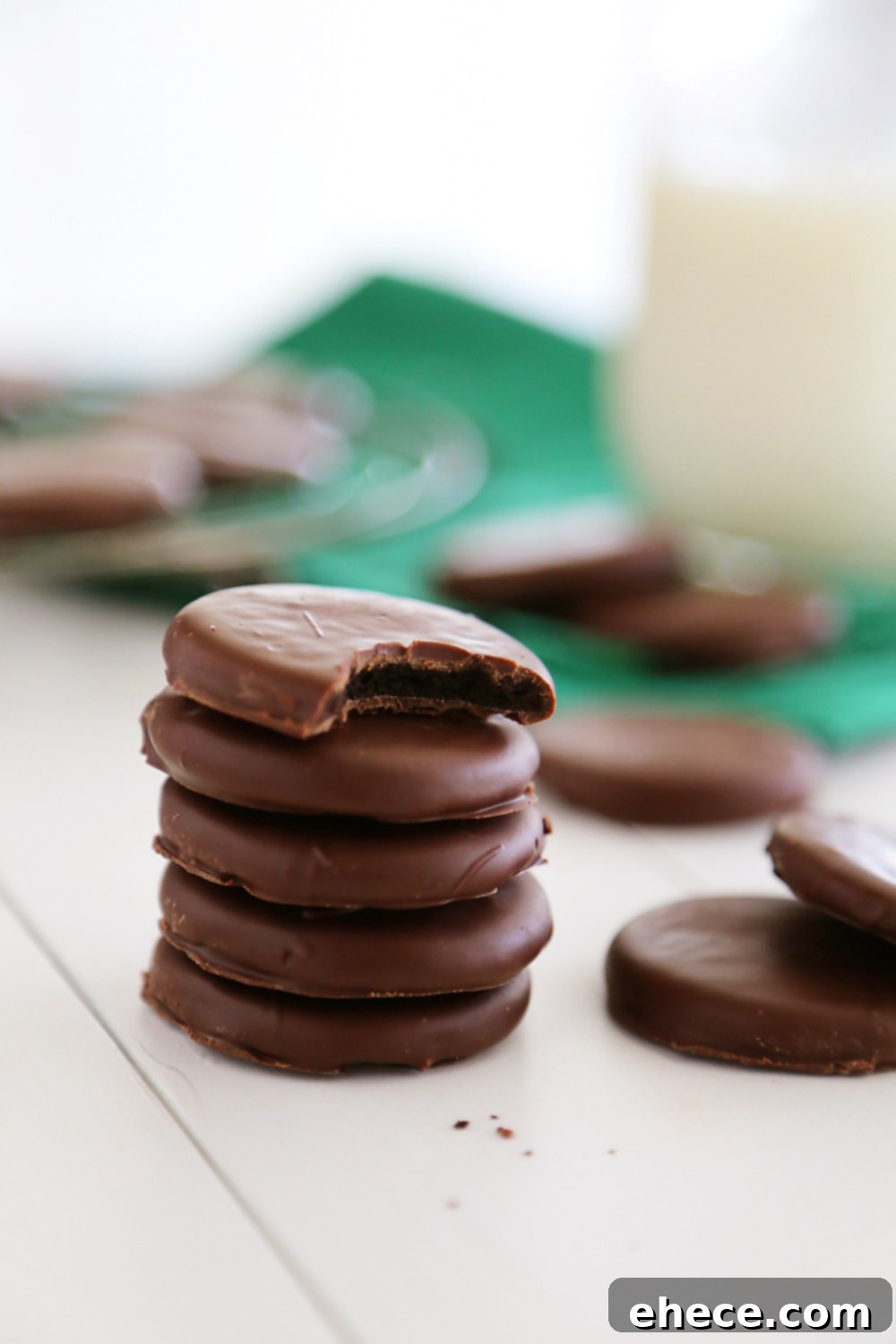 Delicious 3-Ingredient Oreo Thin Mints stacked on a plate, showcasing their perfect chocolate coating and inviting texture. A homemade alternative to Girl Scout cookies.
