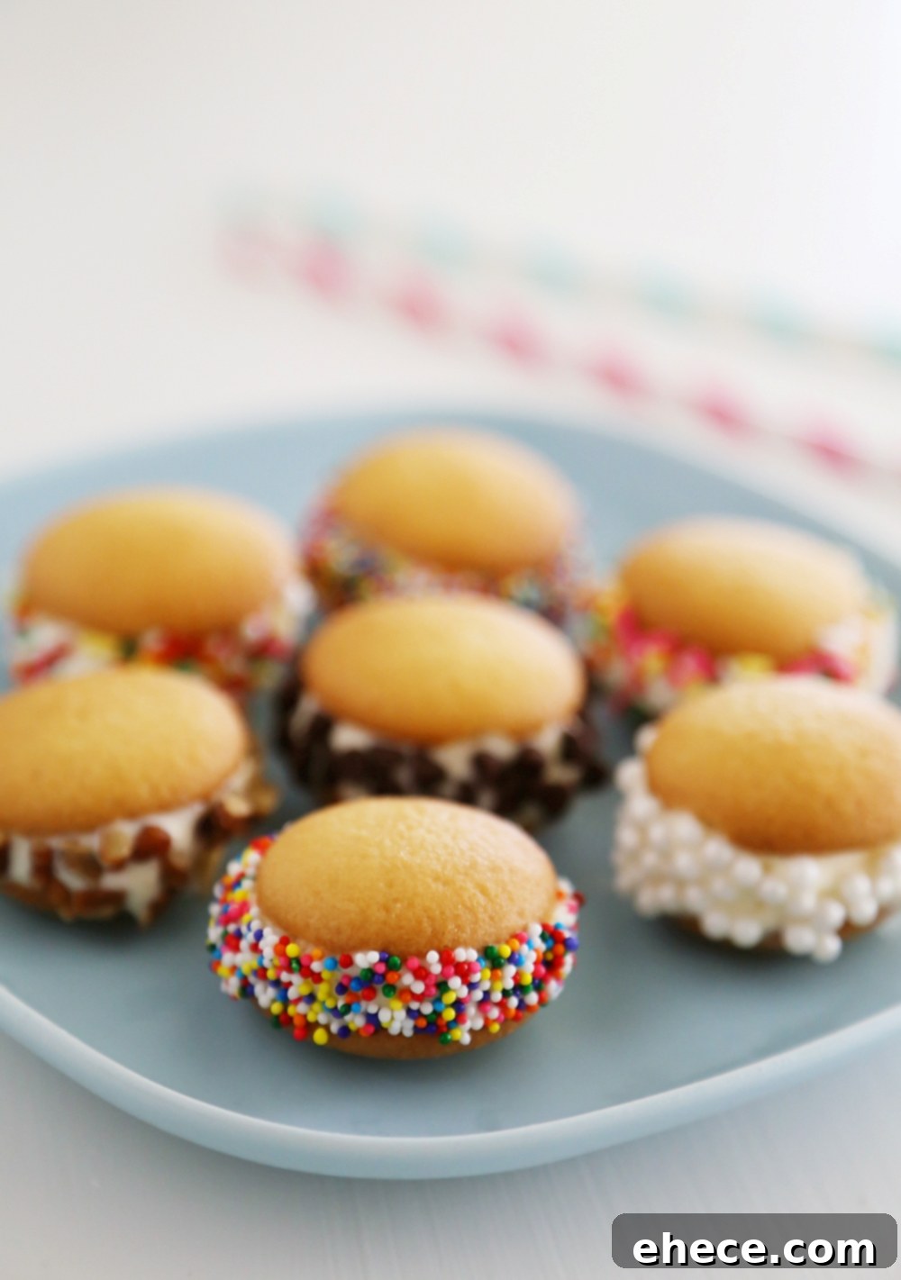 Mini Vanilla Wafer Ice Cream Sandwiches – The perfect quick + easy frozen treat! Roll in your favorite toppings and enjoy. thecomfortofcooking.com