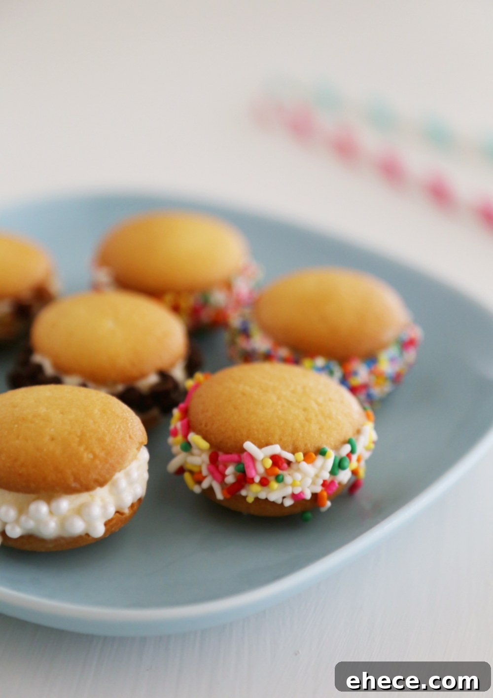 Mini Vanilla Wafer Ice Cream Sandwiches – The perfect quick + easy frozen treat! Roll in your favorite toppings and enjoy. thecomfortofcooking.com