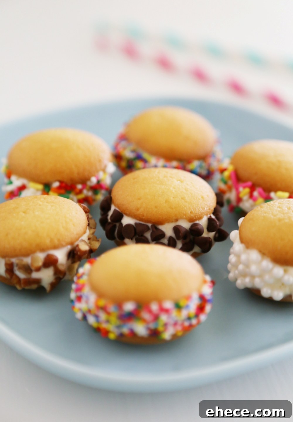 Mini Vanilla Wafer Ice Cream Sandwiches – The perfect quick + easy frozen treat! Roll in your favorite toppings and enjoy. thecomfortofcooking.com