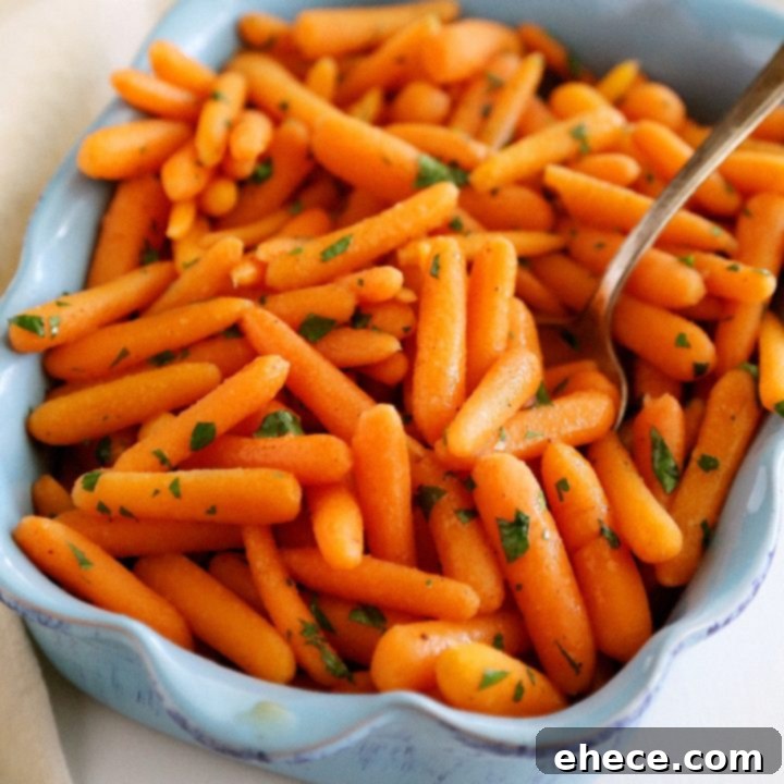 A beautifully plated dish of honey-glazed baby carrots, garnished with fresh parsley.