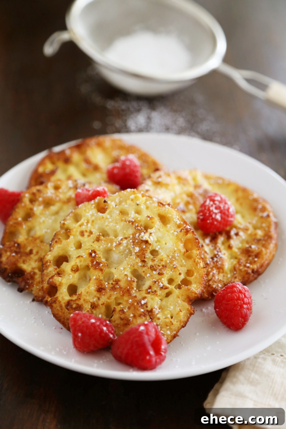 Nook and Cranny French Toast 3 Close-up of golden-brown English Muffin French Toast halves soaking up the custard, ready for cooking.