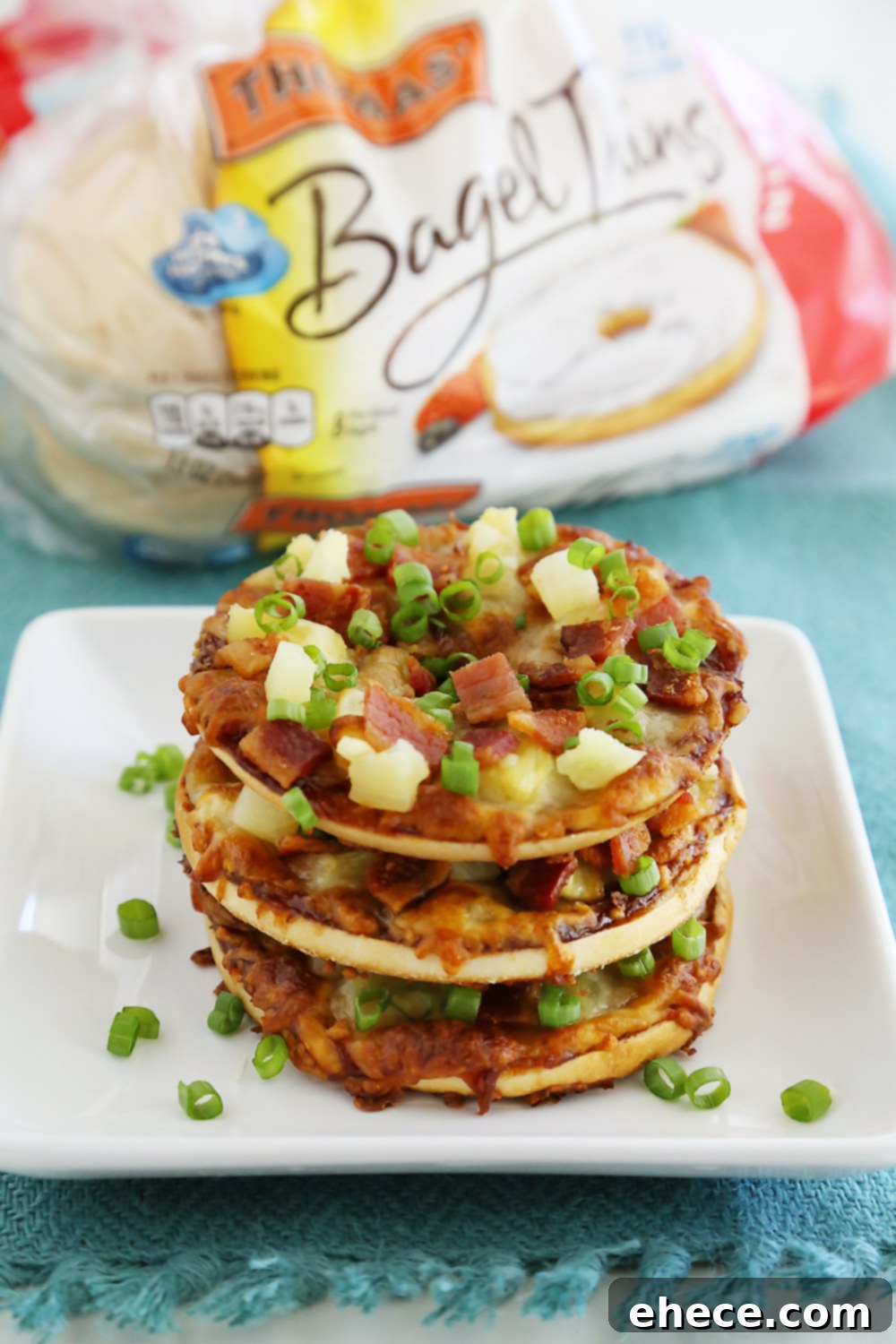 Close-up of baked bacon and pineapple on a bagel thin pizza