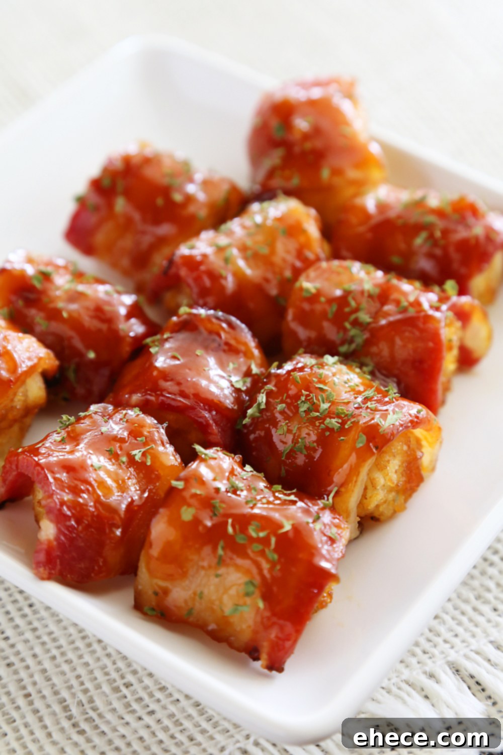 BBQ Bacon Wrapped Tater Tot Bites - Crispy tater tots wrapped in applewood smoked bacon and coated with a tangy homemade barbecue sauce! Thecomfortofcooking.com