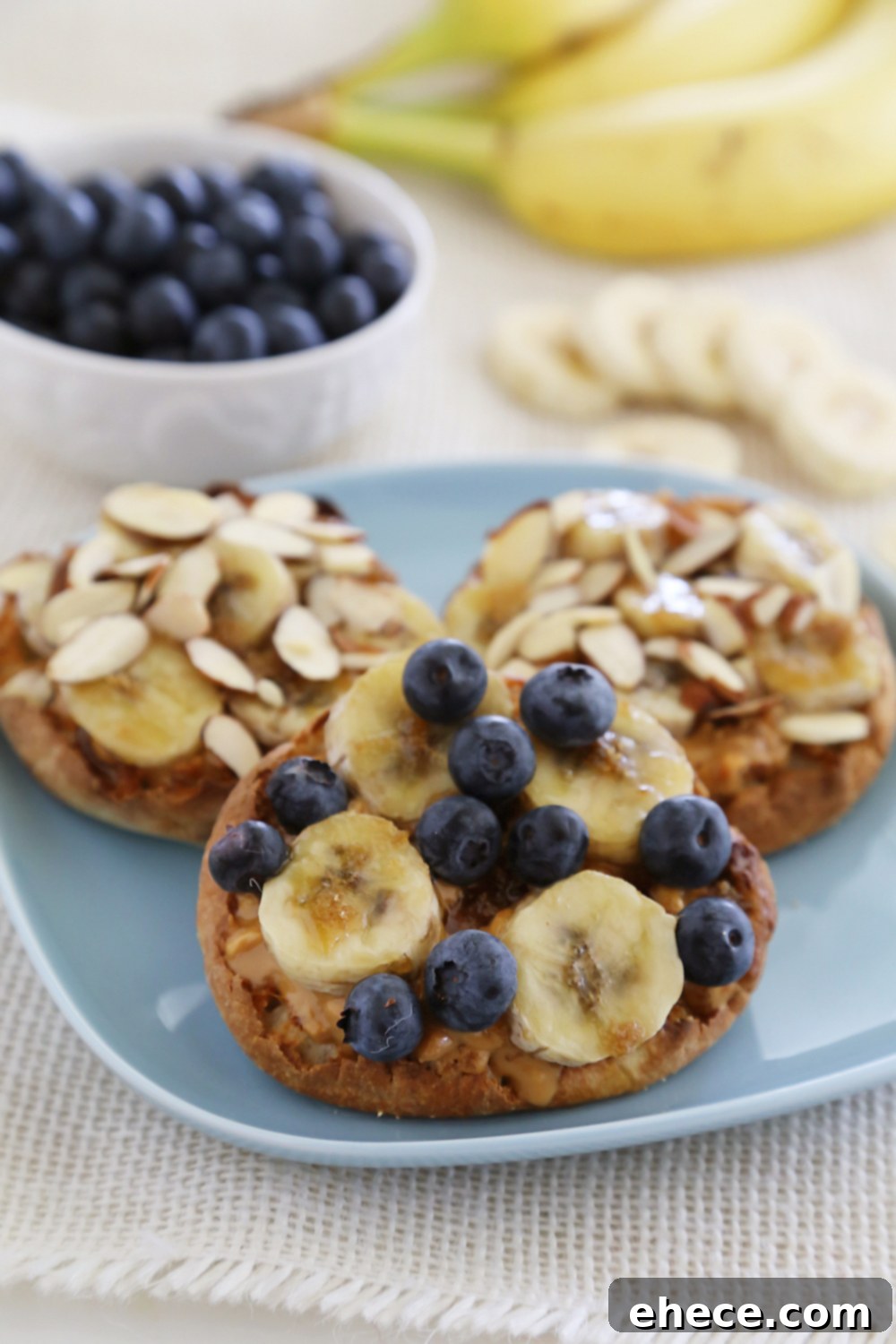 Caramelized Banana Peanut Butter English Muffins 2 Brûléed Banana and Peanut Butter English Muffins with fresh blueberries and sliced almonds, a perfect healthy and filling breakfast recipe.