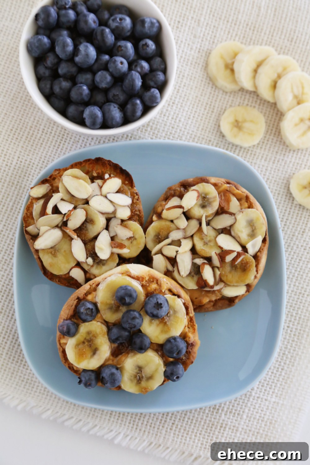 Caramelized Banana Peanut Butter English Muffins 5 Finished Brûléed Banana and Peanut Butter English Muffins served with fresh blueberries and sliced almonds.