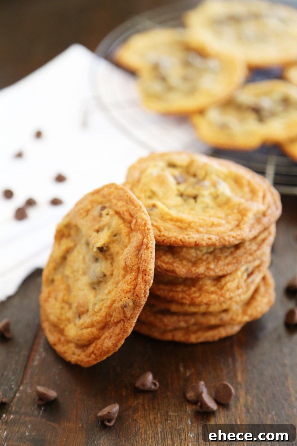 Thin and Chewy Chocolate Chip Cookies – Super buttery, chewy and irresistibly easy to bake. Achieve bakery-style perfection at home. TheComfortofCooking.com