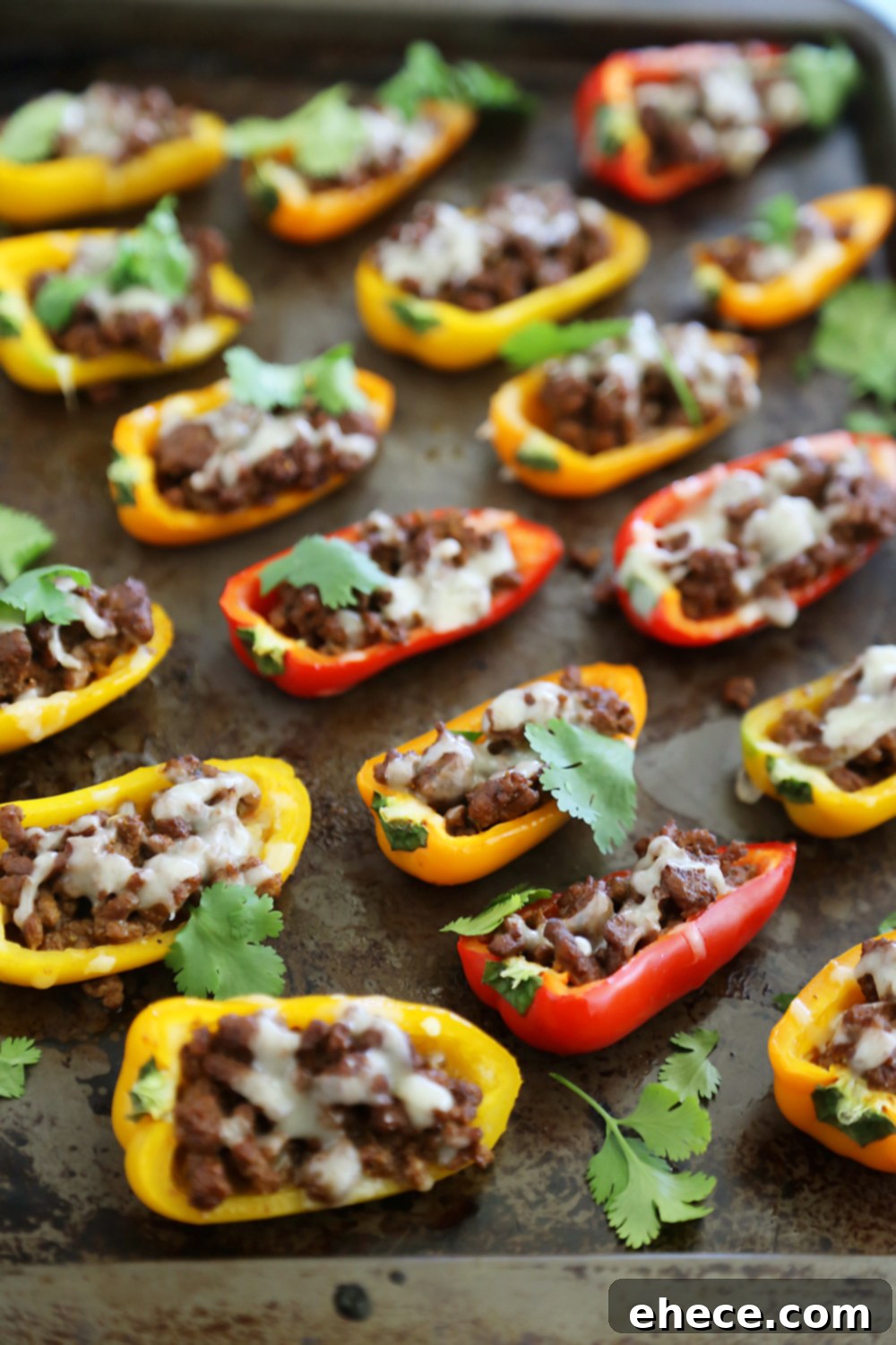 Close-up of Mini Taco Stuffed Peppers being filled with ground meat mixture, highlighting the ease of preparation.
