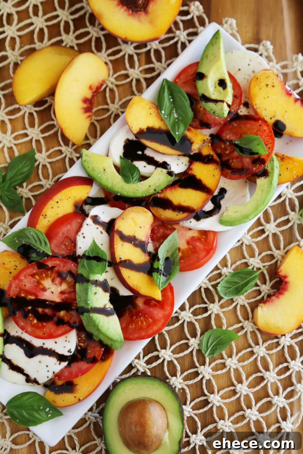 Sun-Kissed Peach and Avocado Caprese 4 Artfully arranged Peach and Avocado Caprese Salad on a rustic platter, ready to be served. Thecomfortofcooking.com