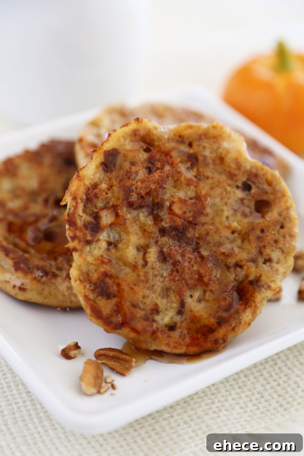 Plate of Pumpkin Vanilla English Muffin French Toast ready to be served, highlighting its fluffy texture and inviting color.
