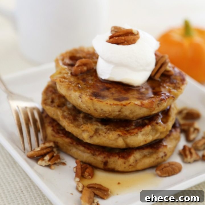 Harvest Pumpkin Vanilla English Muffin French Toast 7 Finished Pumpkin Vanilla English Muffin French Toast, garnished with whipped cream and syrup on a white plate, ready to be served.