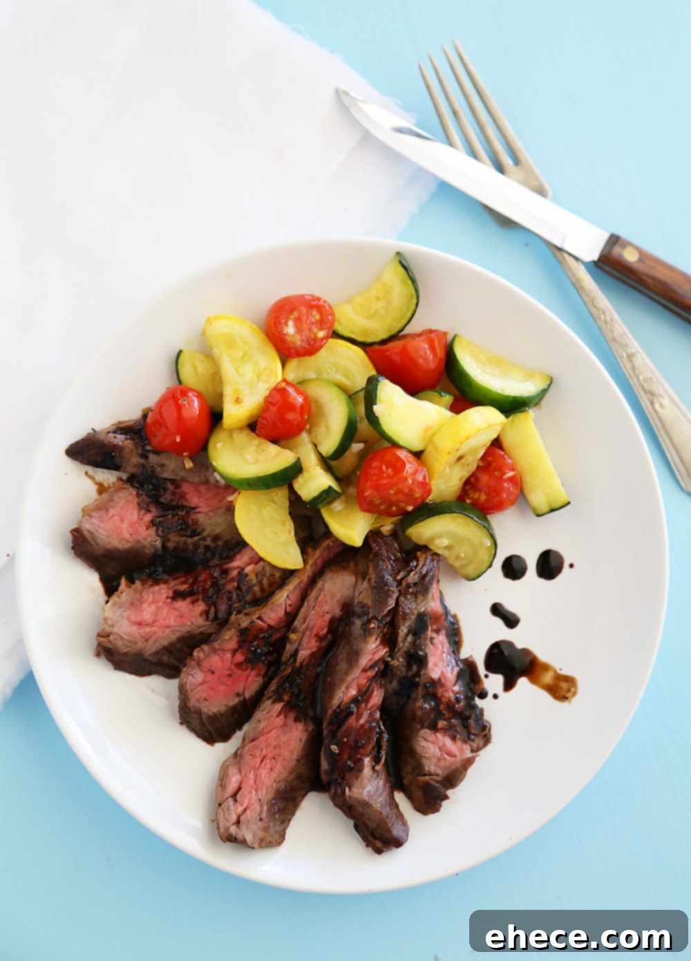 A close-up shot of the tender, juicy Skillet Balsamic Skirt Steak, revealing its perfectly cooked interior and the enticing glaze.