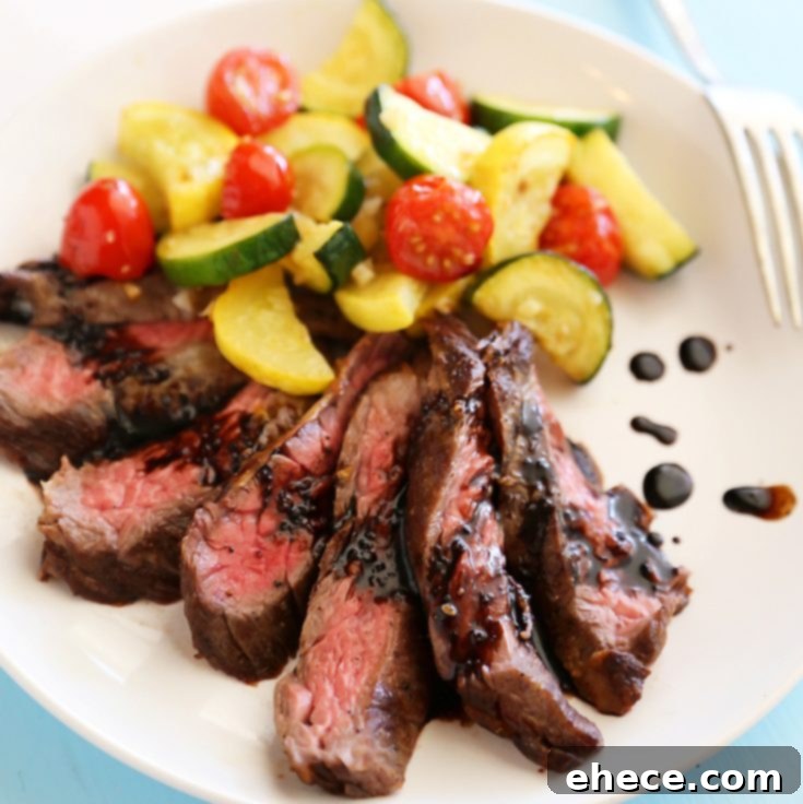A stunning Skillet Balsamic Skirt Steak with Garlic Zucchini, Squash, and Tomatoes dish ready for serving.