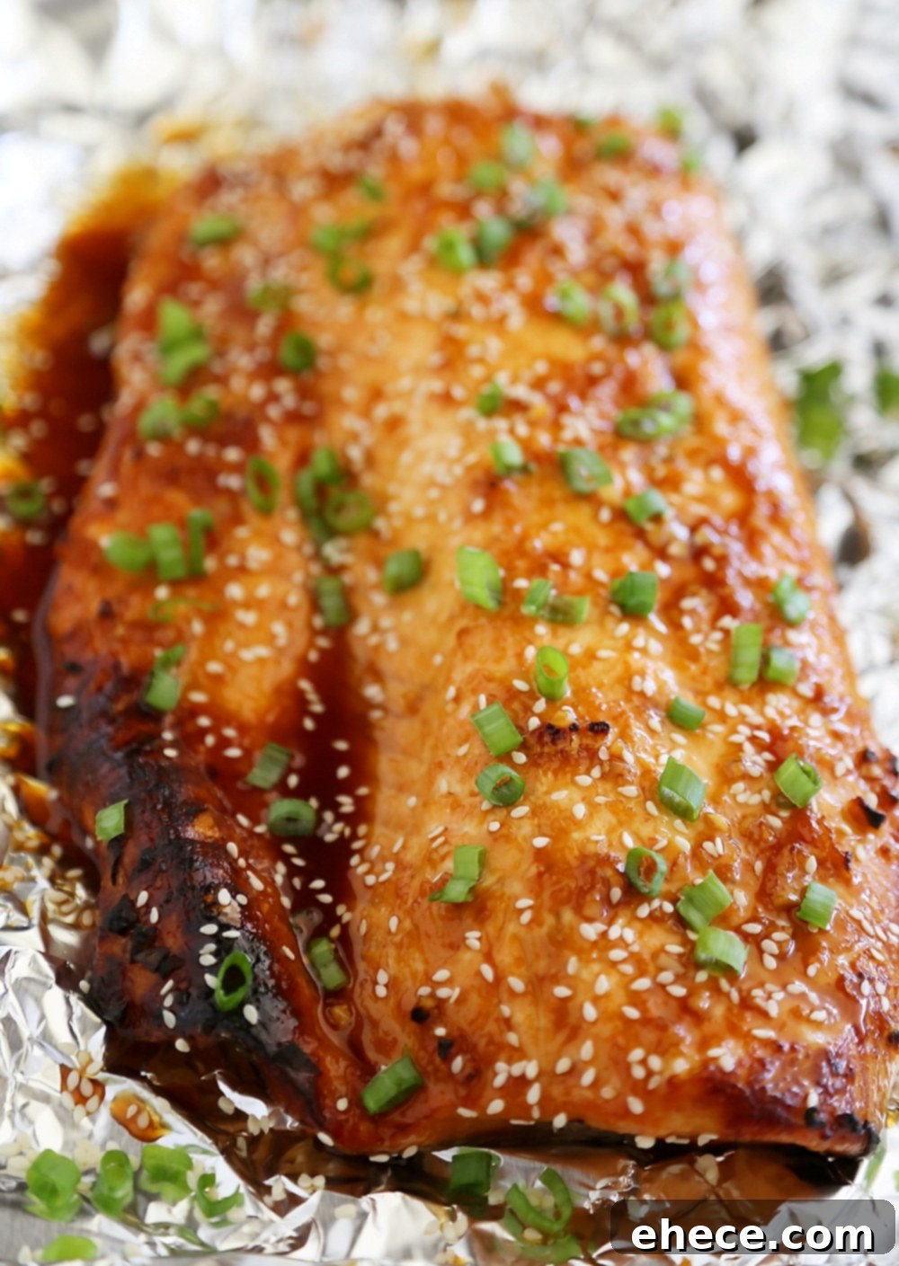 Honey-Soy Asian Salmon in Foil - Raw salmon drizzled with a homemade Asian-inspired glaze, ready for baking.