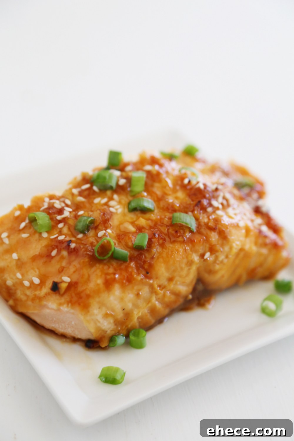 Honey-Soy Asian Salmon in Foil - A close-up of a perfectly cooked salmon fillet, garnished and ready.